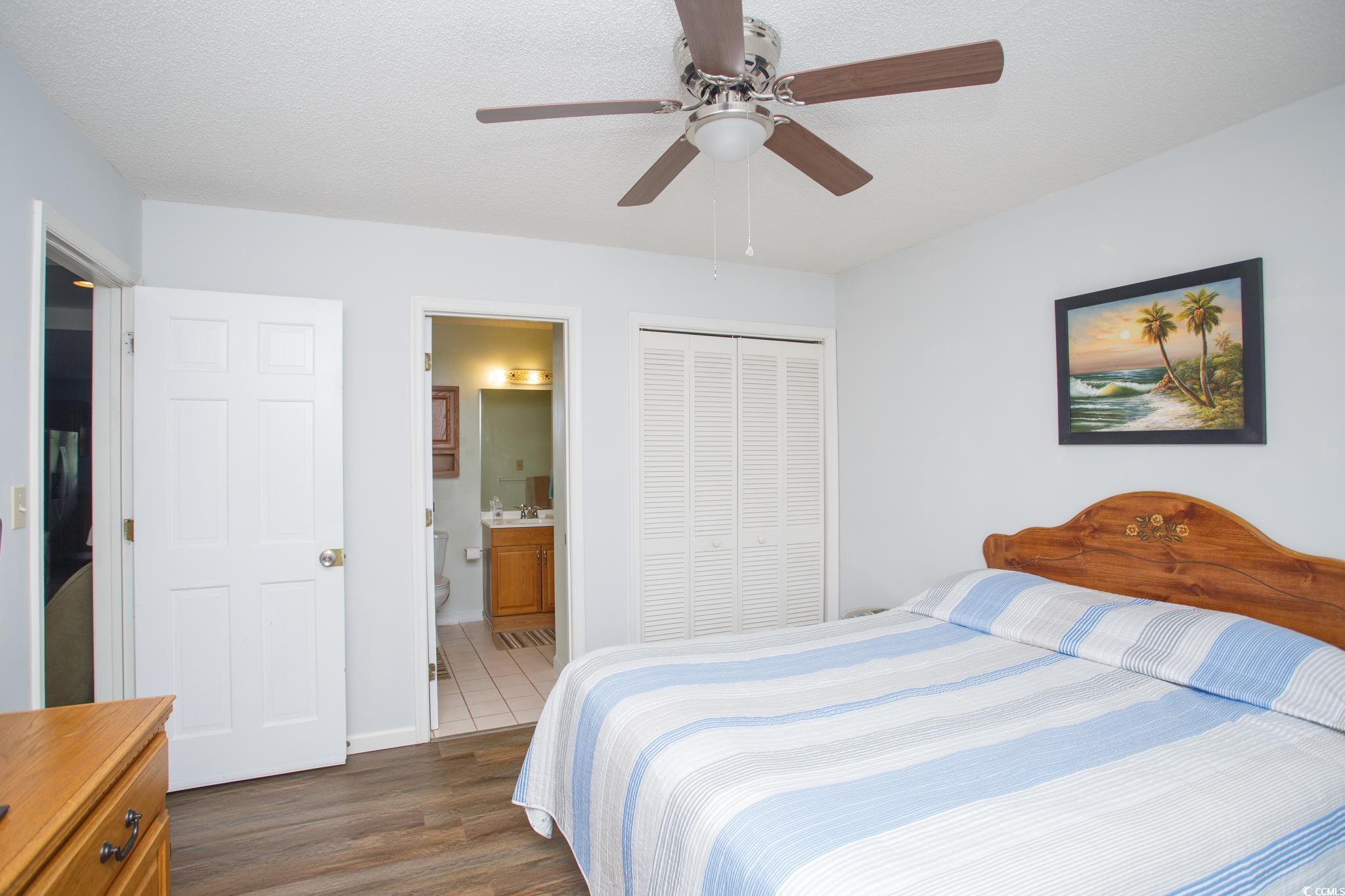 1356 Glenns Bay Road, Unit 201B Surfside Beach, SC 29575 - Photo 16 of 37 Bedroom featuring dark wood-type flooring, a close