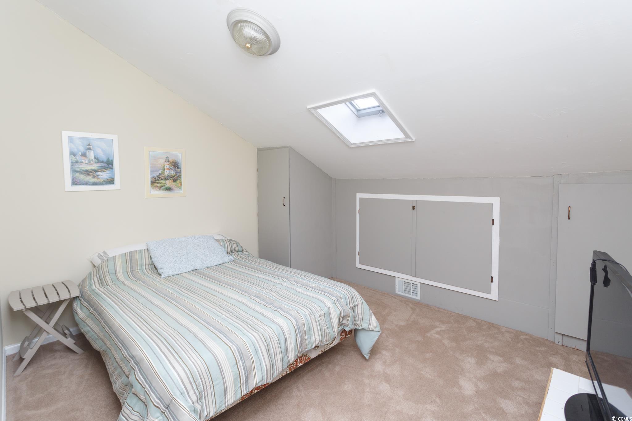 1356 Glenns Bay Road, Unit 201B Surfside Beach, SC 29575 - Photo 24 of 37 Carpeted bedroom with a skylight and lofted ceilin