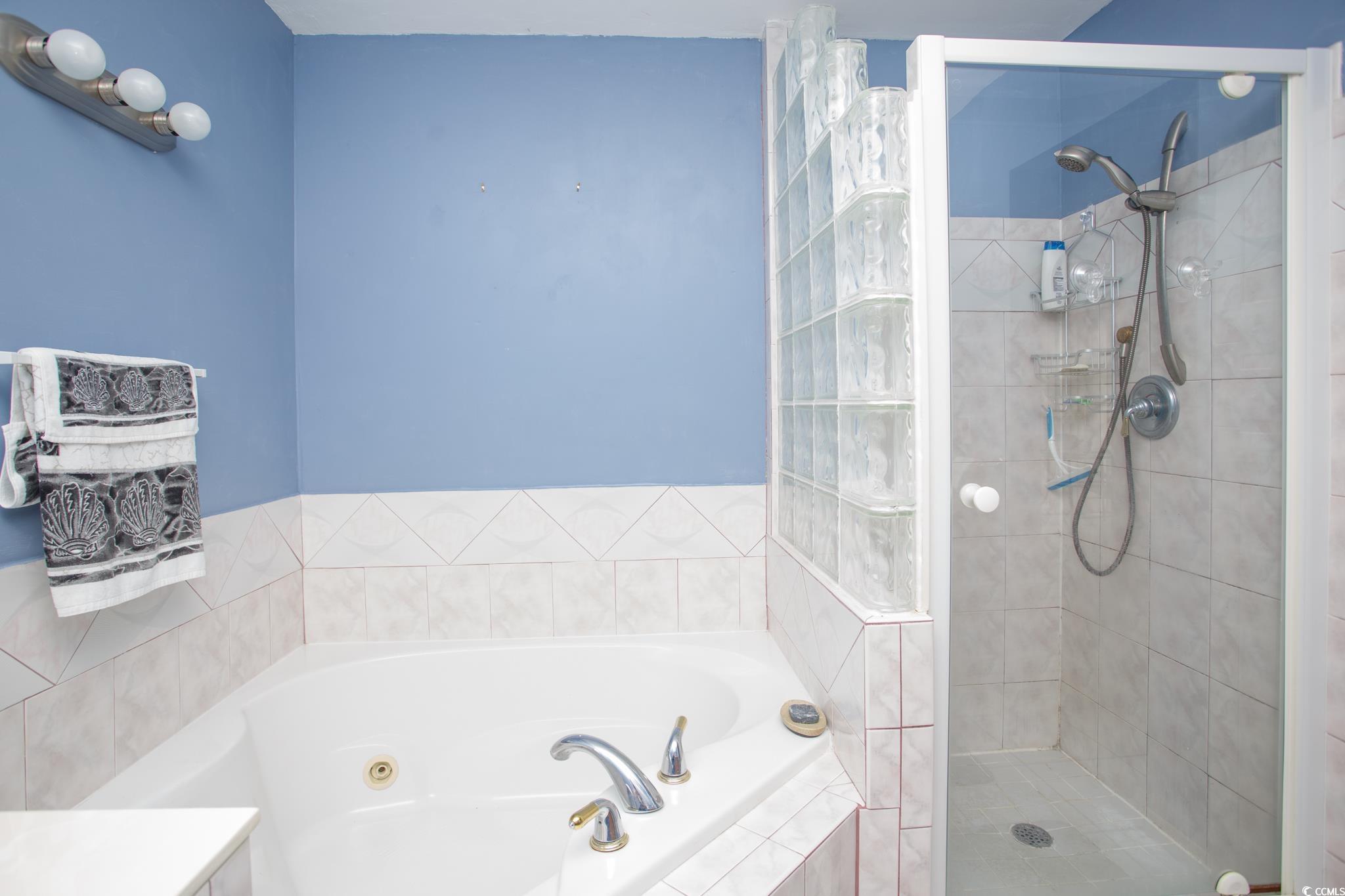 1356 Glenns Bay Road, Unit 201B Surfside Beach, SC 29575 - Photo 26 of 37 Bathroom featuring a garden tub, a shower stall, a
