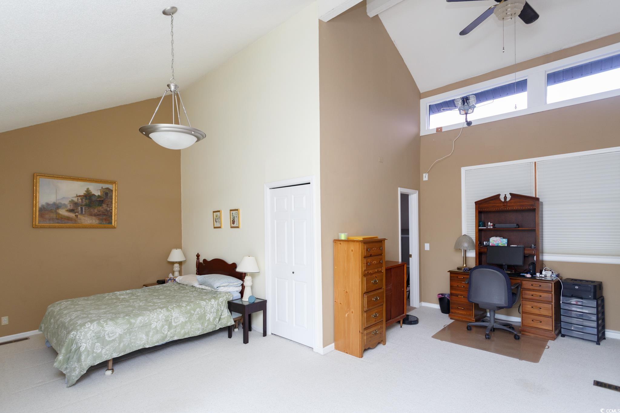 1356 Glenns Bay Road, Unit 201B Surfside Beach, SC 29575 - Photo 28 of 37 Carpeted bedroom featuring high vaulted ceiling, a
