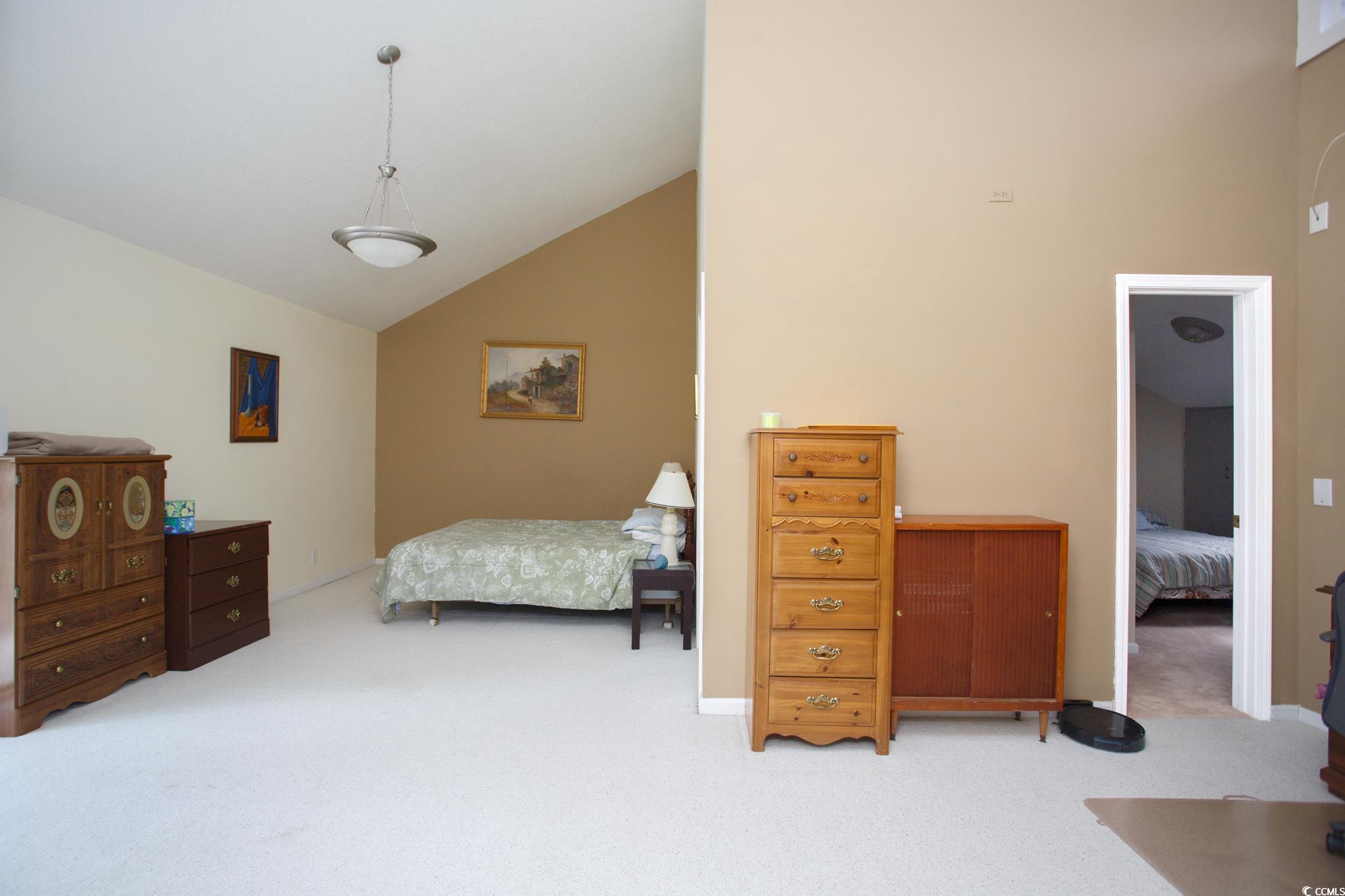 1356 Glenns Bay Road, Unit 201B Surfside Beach, SC 29575 - Photo 32 of 37 Bedroom featuring light colored carpet and high va