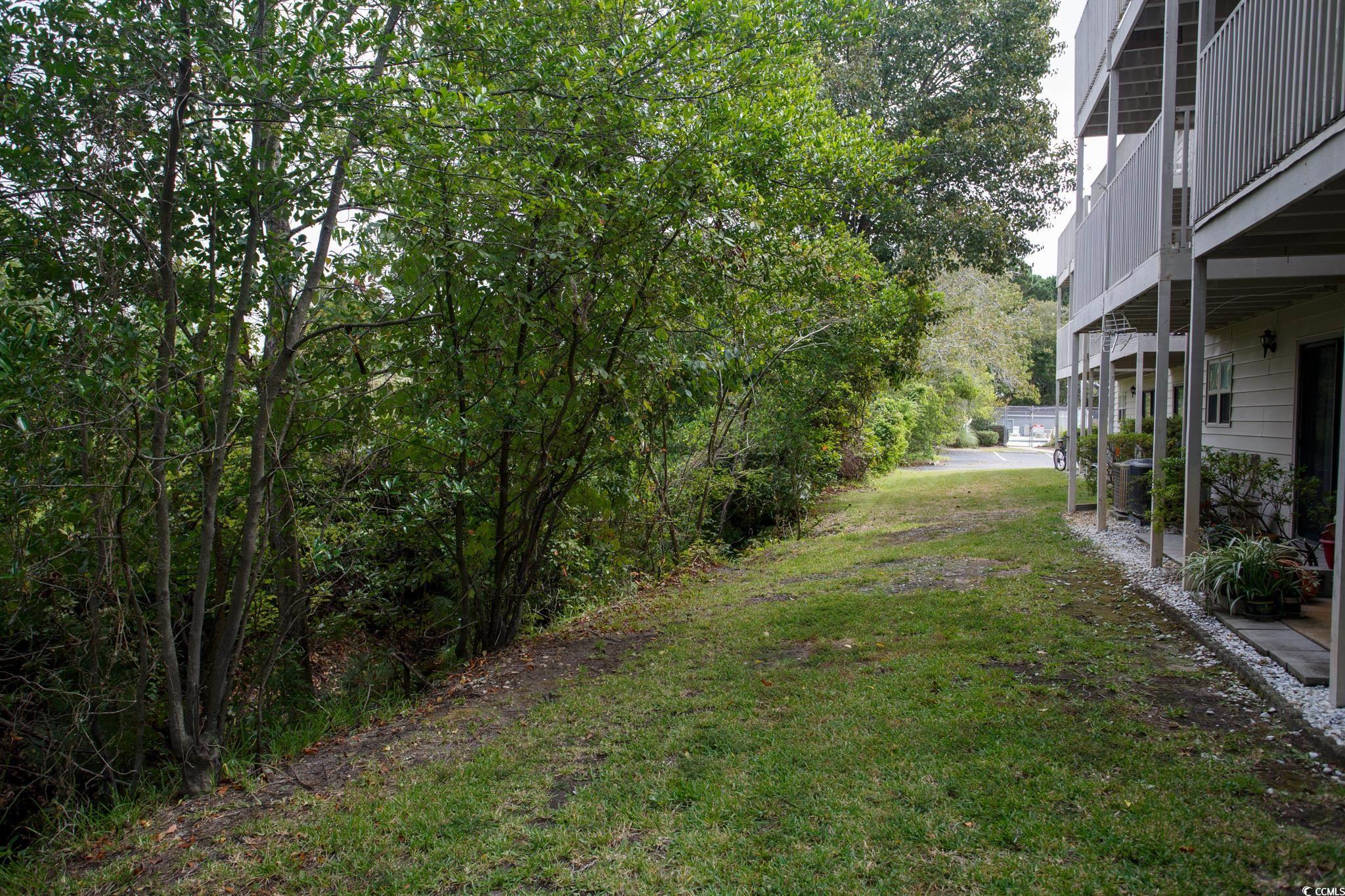 1356 Glenns Bay Road, Unit 201B Surfside Beach, SC 29575 - Photo 34 of 37 View of green lawn