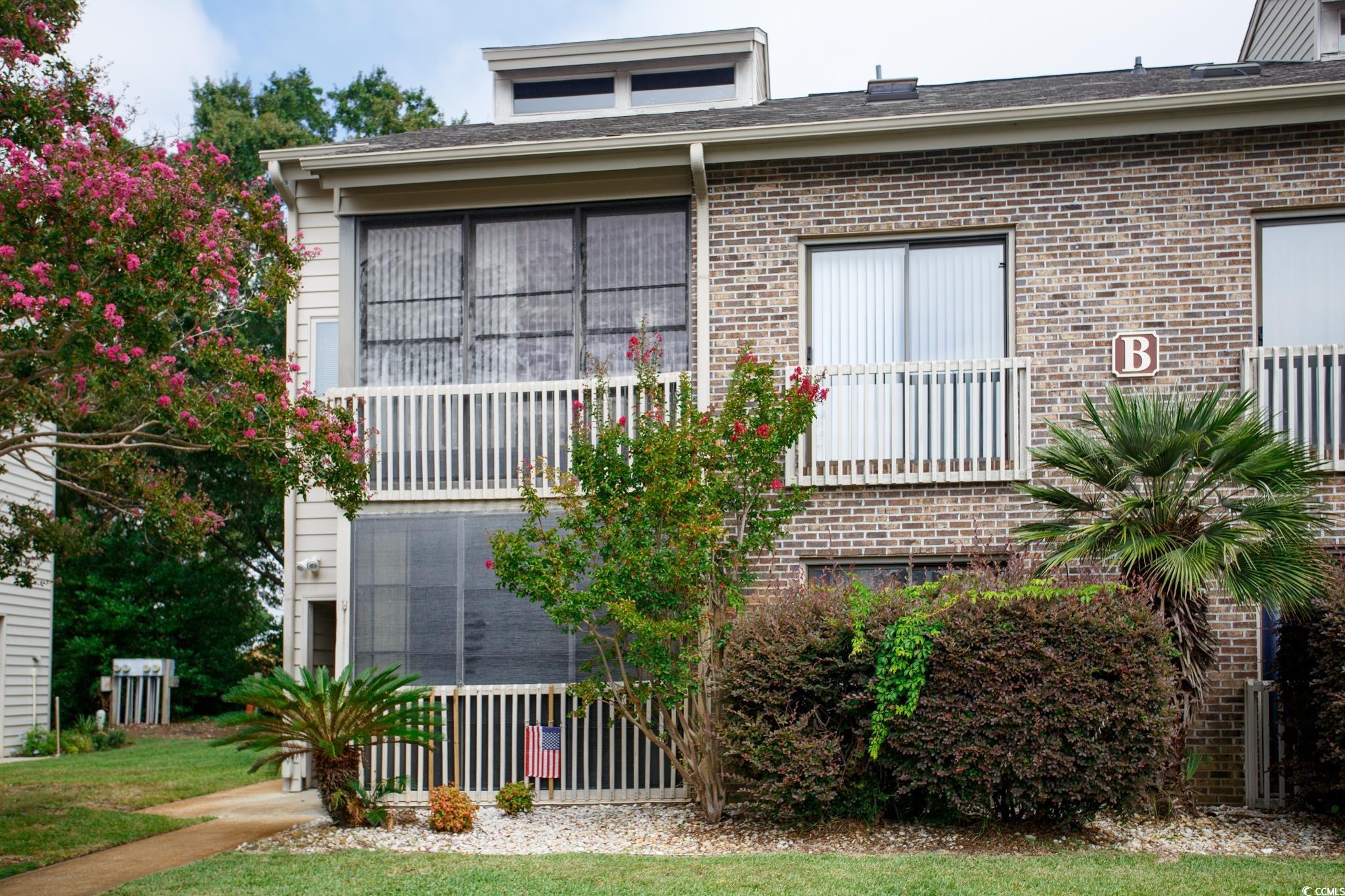 1356 Glenns Bay Road, Unit 201B Surfside Beach, SC 29575 - Photo 36 of 37 View of front facade featuring brick siding and a