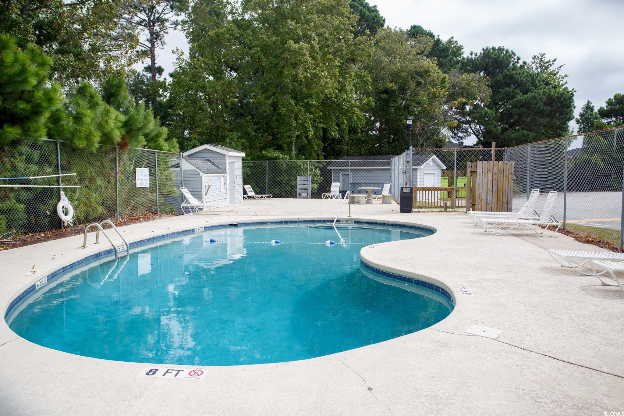 1356 Glenns Bay Road, Unit 201B Surfside Beach, SC 29575 - Photo 37 of 37 Community pool with a patio area and a storage uni