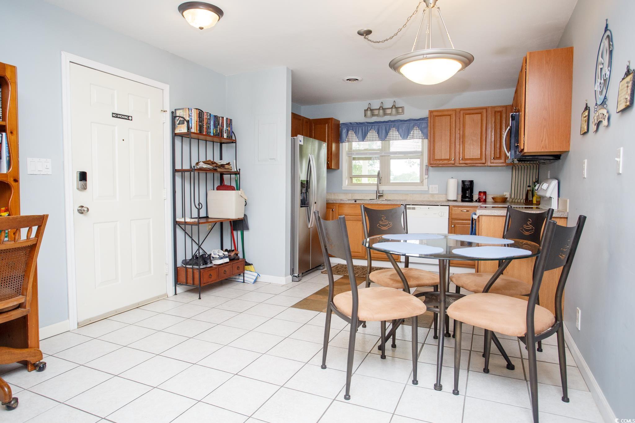 1356 Glenns Bay Road, Unit 201B Surfside Beach, SC 29575 - Photo 8 of 37 Dining room featuring baseboards and light tile pa
