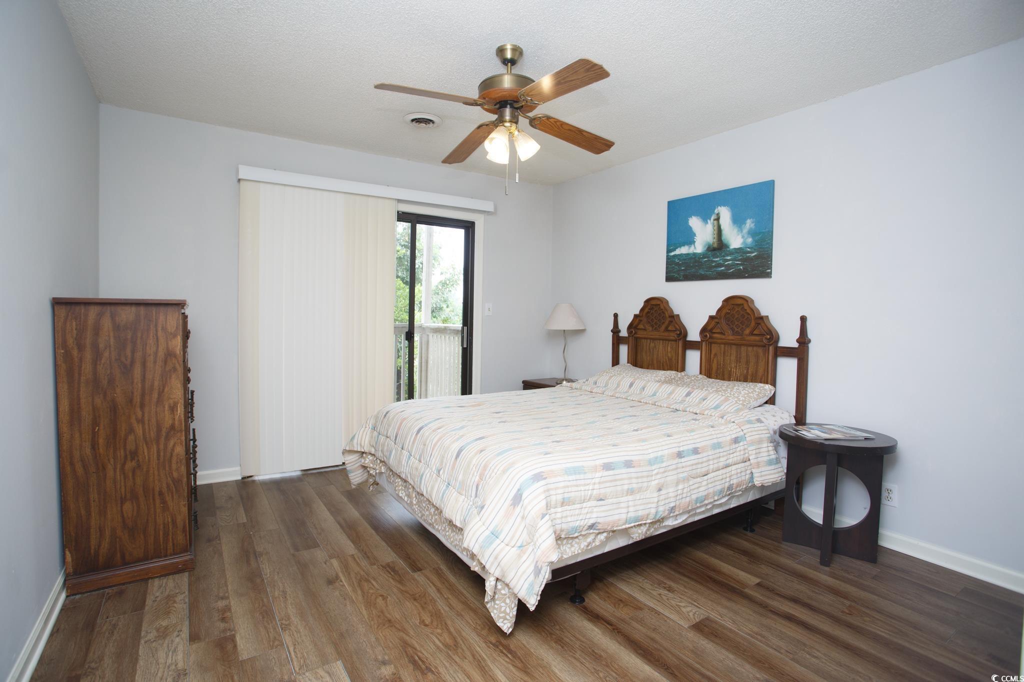1356 Glenns Bay Road, Unit 201B Surfside Beach, SC 29575 - Photo 9 of 37 Bedroom featuring wood finished floors, access to