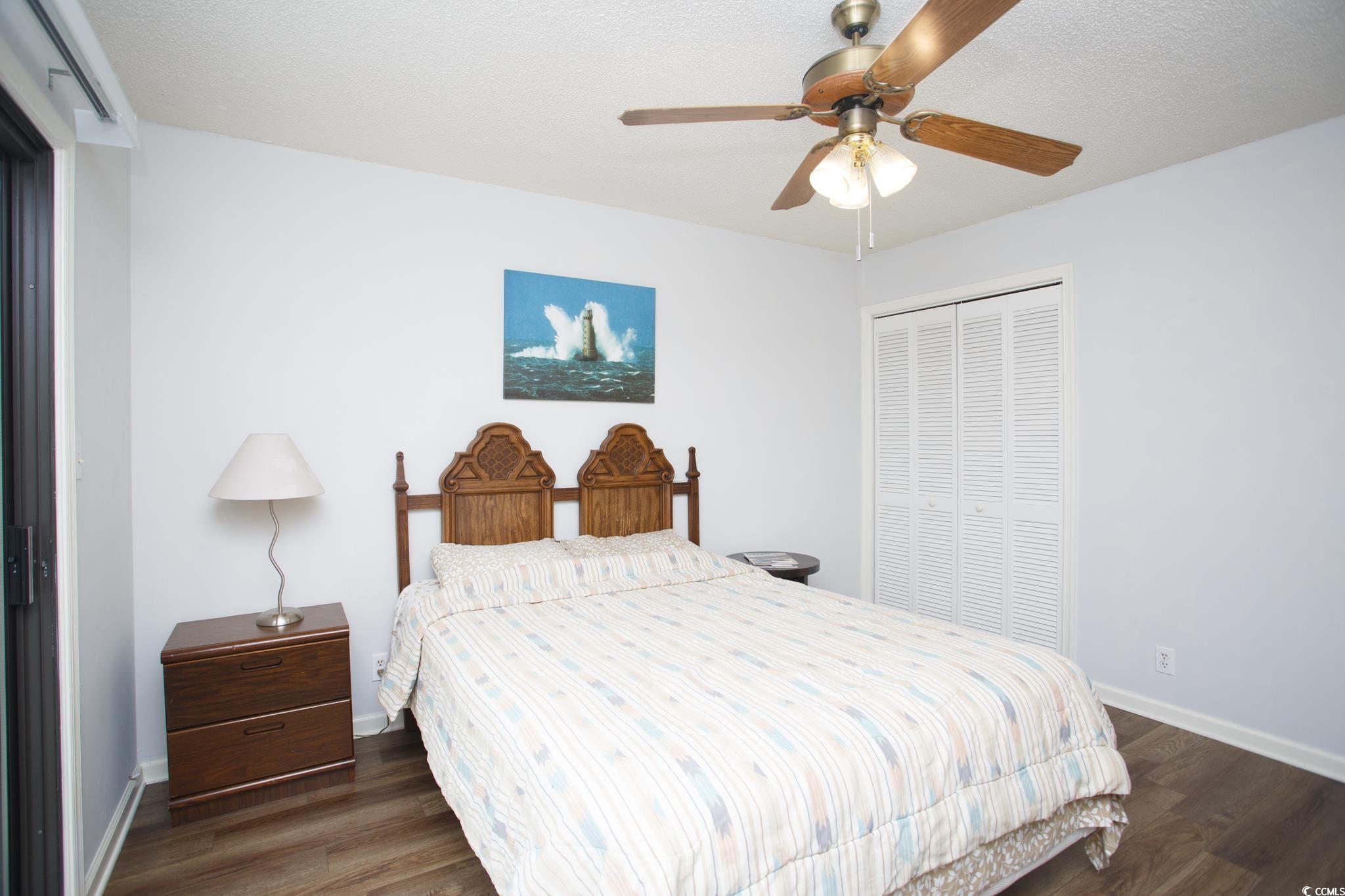 1356 Glenns Bay Road, Unit 201B Surfside Beach, SC 29575 - Photo 10 of 37 Bedroom featuring a closet, dark wood finished flo