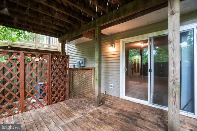 a view of empty room with wooden floor and floor to ceiling window