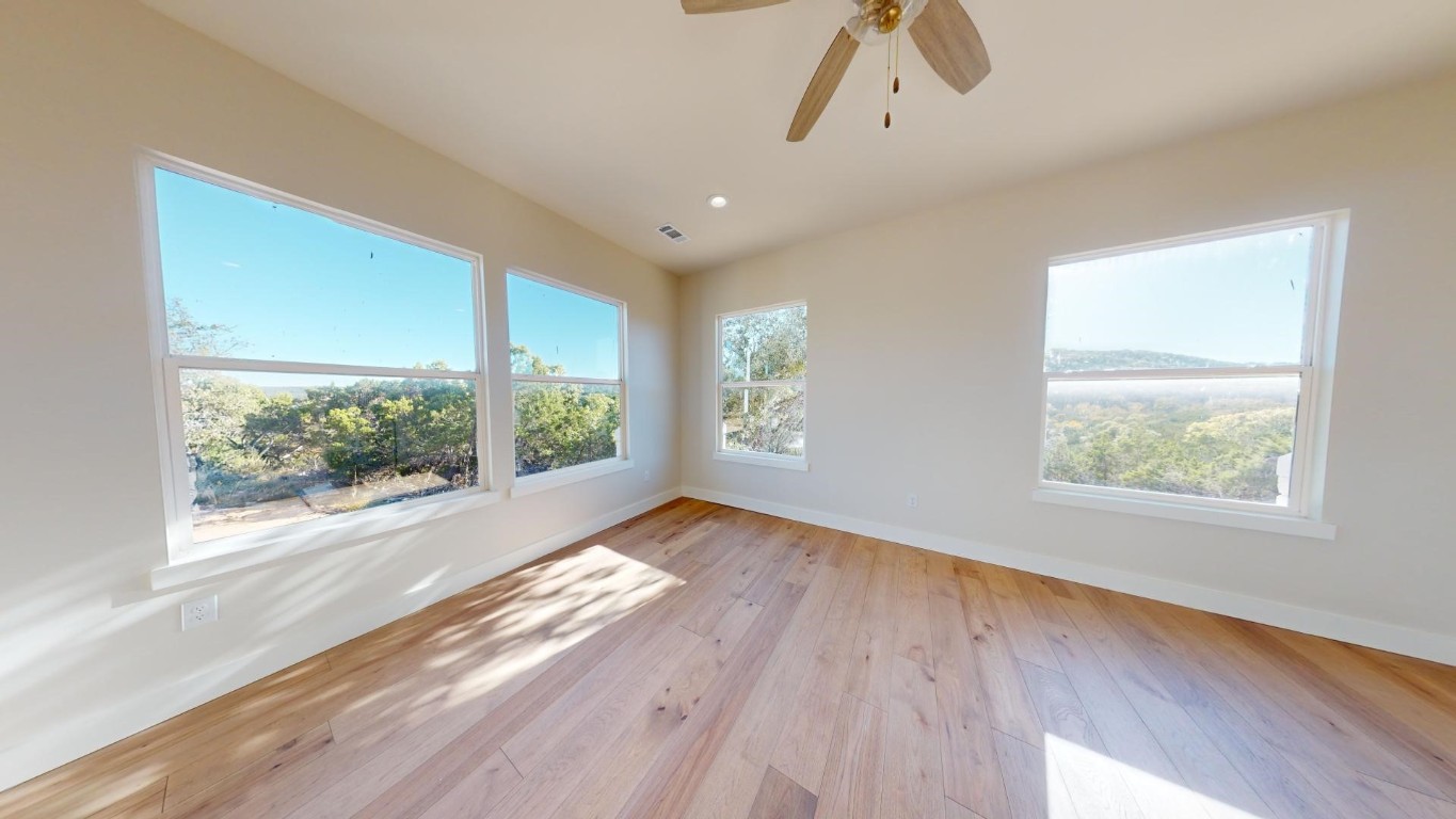 17307 West Reed Park Road Leander, TX 78645 - Photo 19 of 19 a view of an empty room with wooden floor and a window