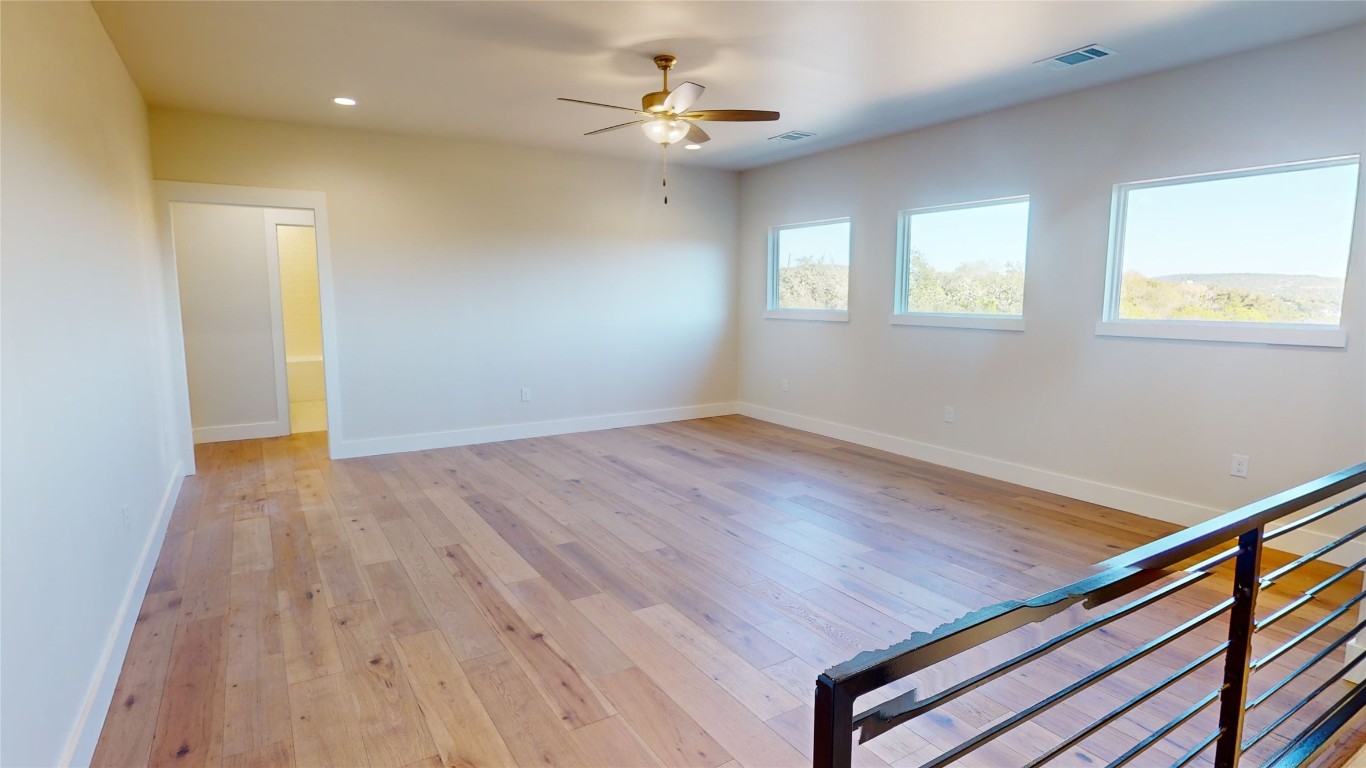 17307 West Reed Park Road Leander, TX 78645 - Photo 4 of 19 wooden floor in an empty room with a window