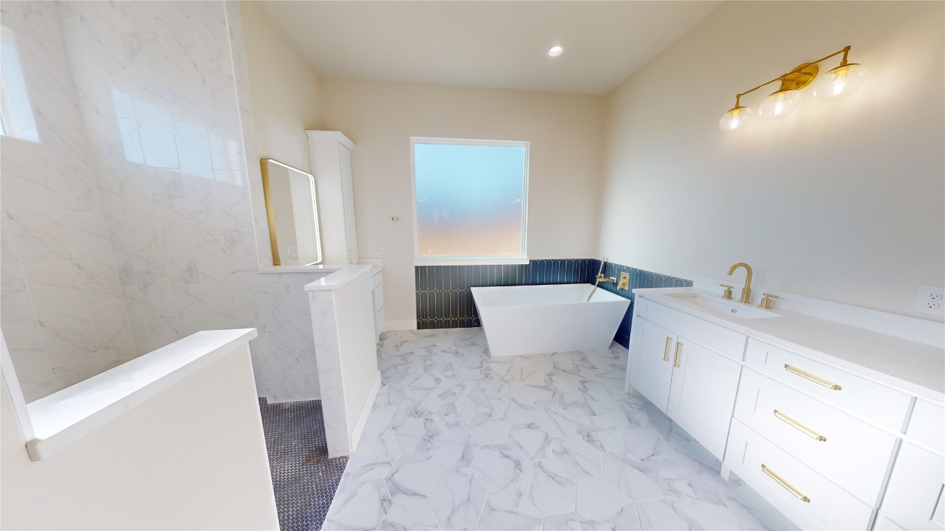 17307 West Reed Park Road Leander, TX 78645 - Photo 5 of 19 a large white tub sitting in a bathroom