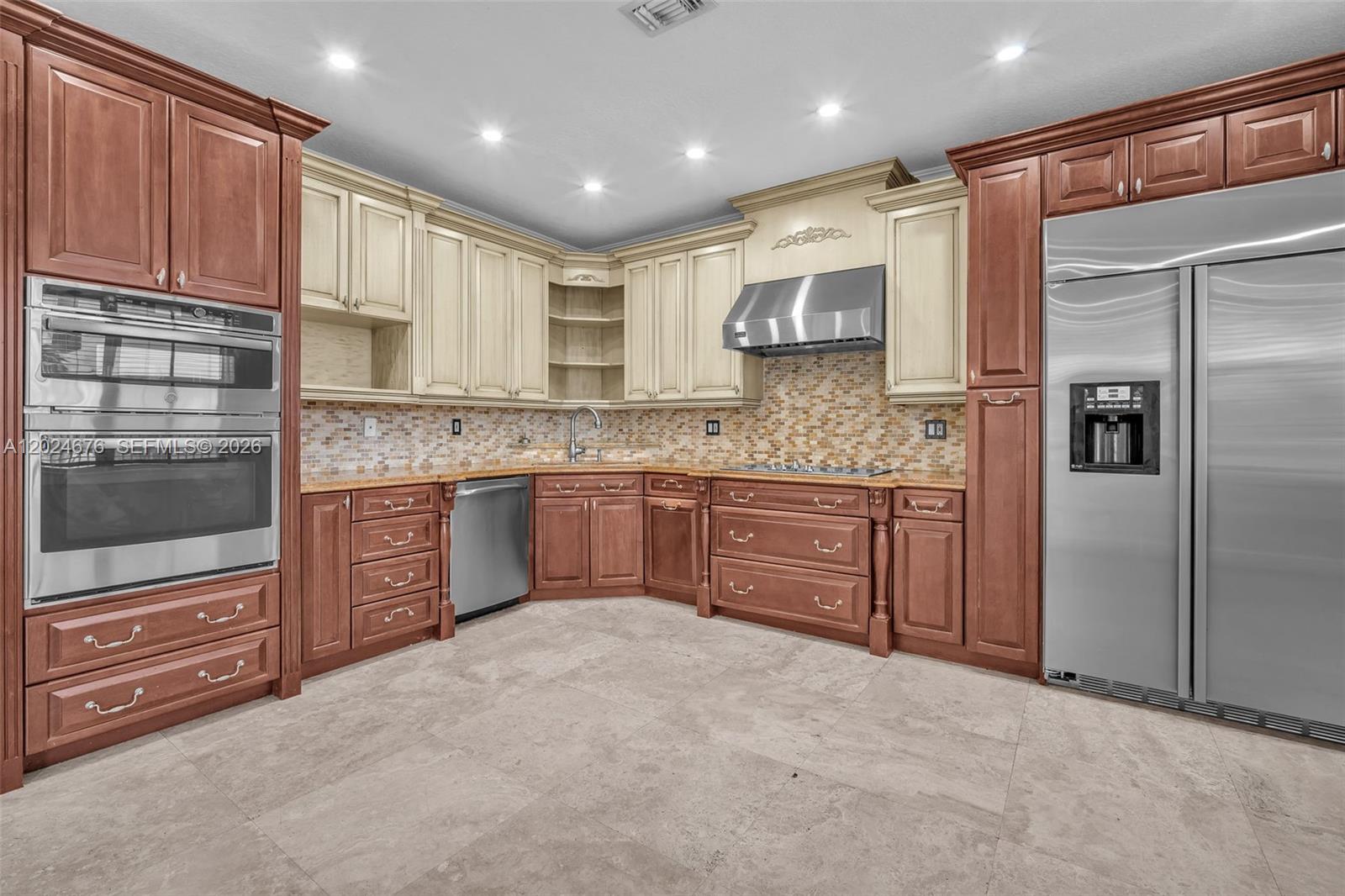 2155 Southwest 156th Court Miami, FL 33185 - Photo 21 of 57 a kitchen with stainless steel appliances granite countertop a refrigerator and a stove top oven