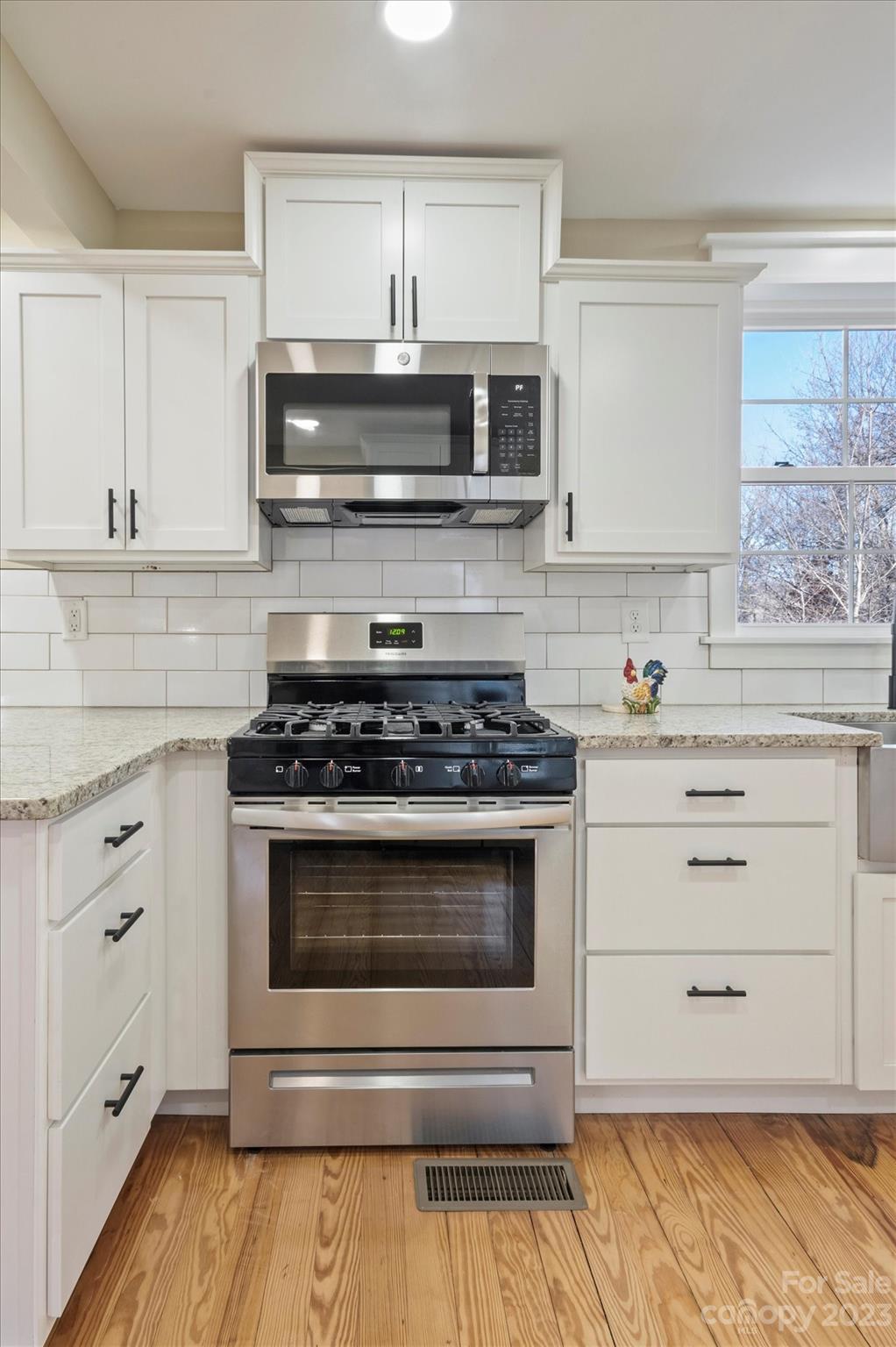 969 Peniel Road Columbus, NC 28722 - Photo 11 of 32 a kitchen with stainless steel appliances granite countertop a stove microwave and cabinets