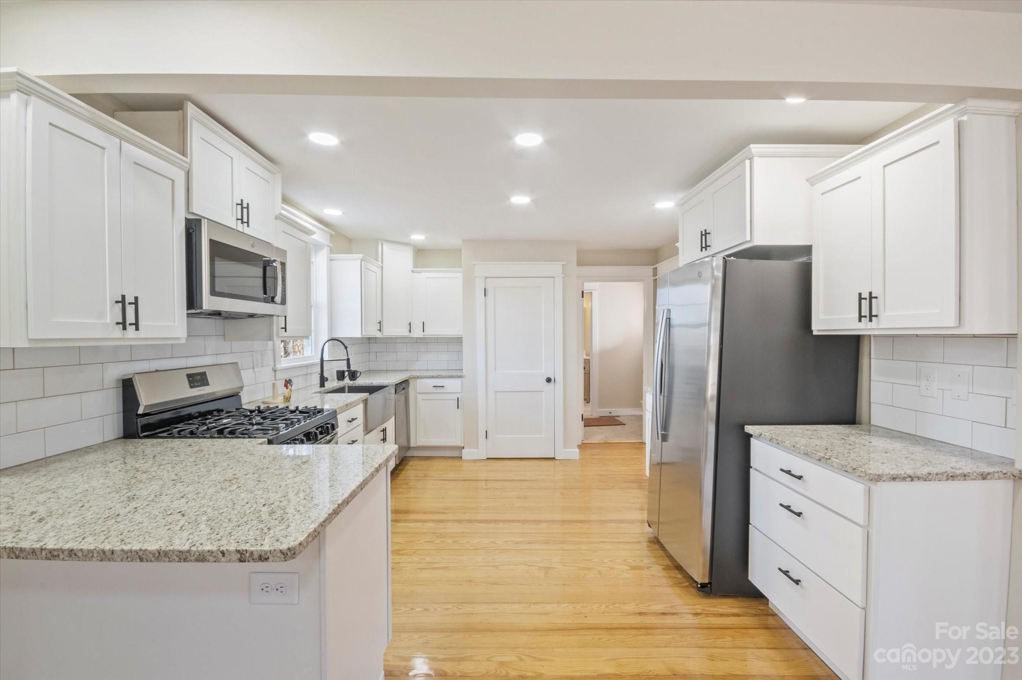 969 Peniel Road Columbus, NC 28722 - Photo 13 of 32 a kitchen with stainless steel appliances granite countertop a refrigerator a stove and a sink