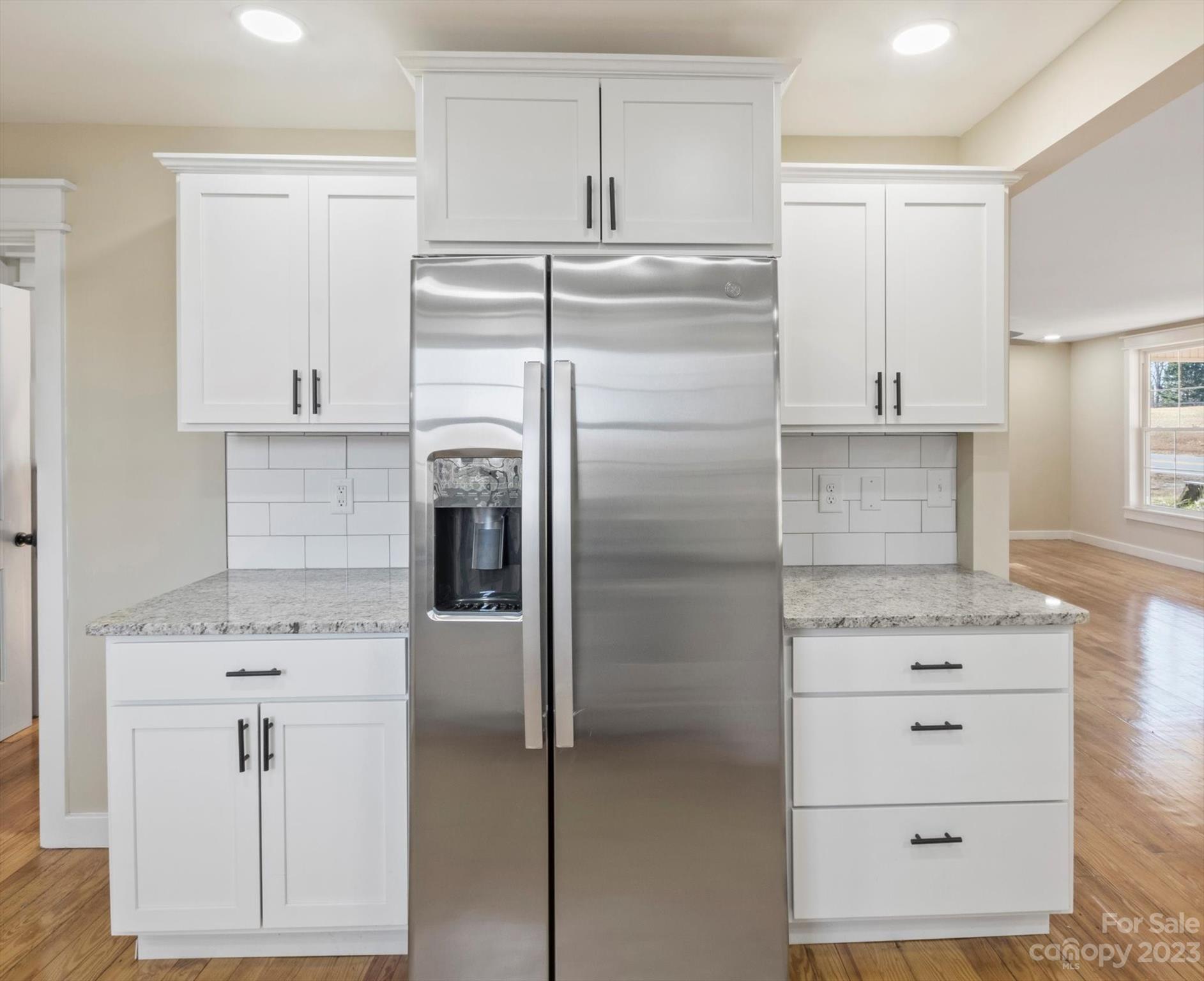 969 Peniel Road Columbus, NC 28722 - Photo 14 of 32 a kitchen with white cabinets and stainless steel appliances