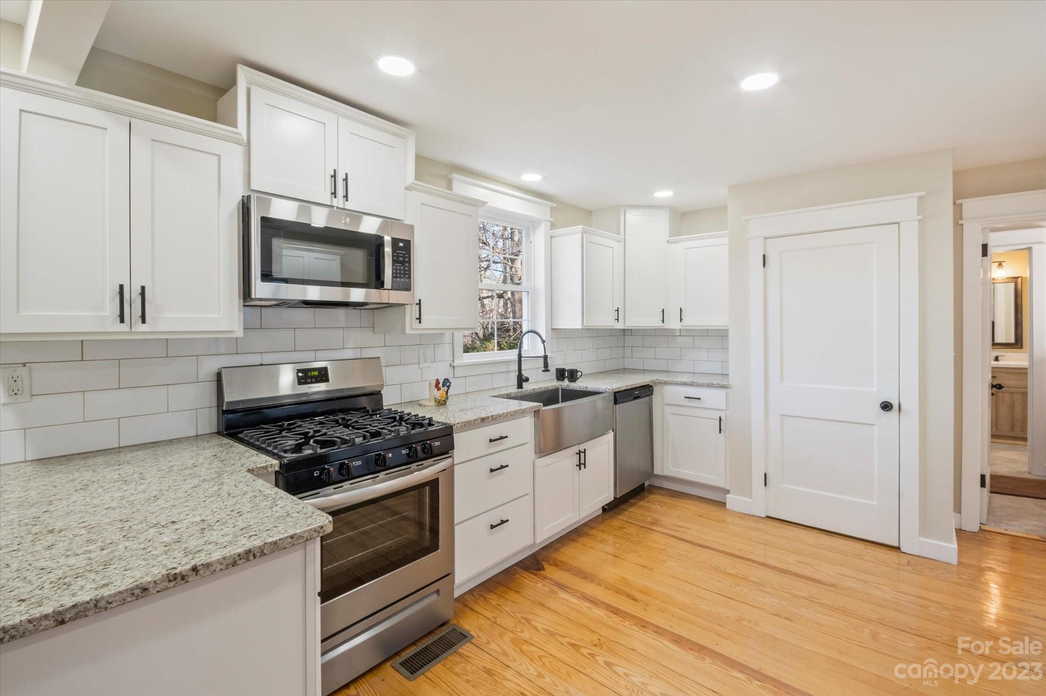 969 Peniel Road Columbus, NC 28722 - Photo 15 of 32 a kitchen with stainless steel appliances granite countertop a stove a sink and a microwave