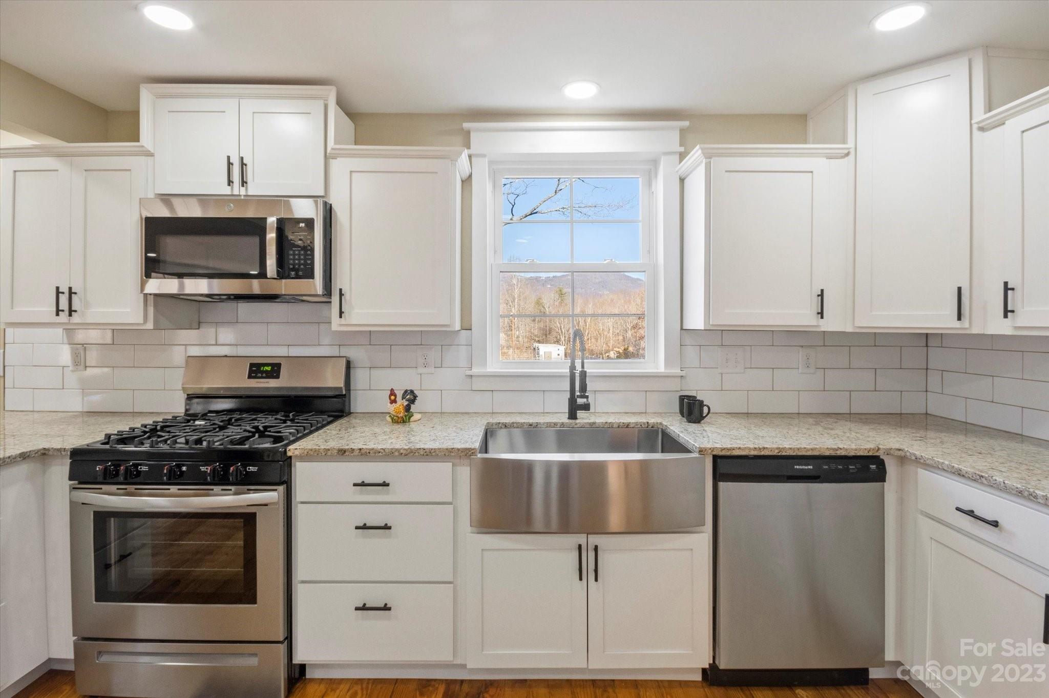 969 Peniel Road Columbus, NC 28722 - Photo 16 of 32 a kitchen with white cabinets stainless steel appliances and sink