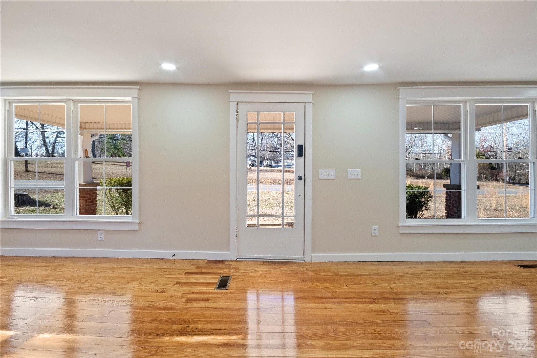 969 Peniel Road Columbus, NC 28722 - Photo 18 of 32 a view of an empty room with wooden floor and a window