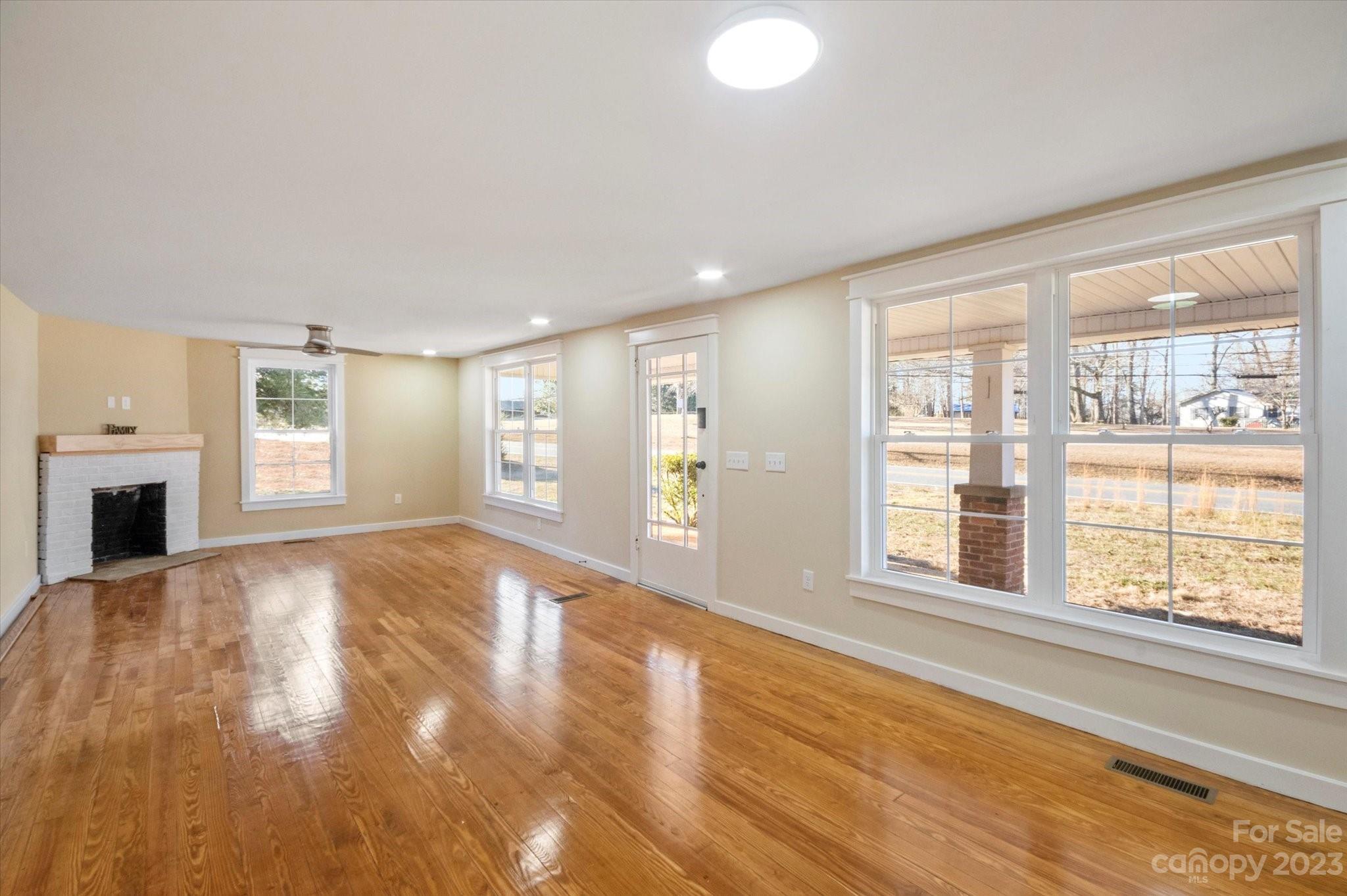 969 Peniel Road Columbus, NC 28722 - Photo 27 of 32 a view of an empty room with a window and fireplace