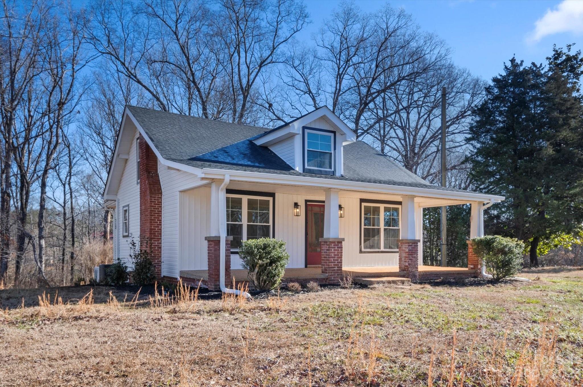 969 Peniel Road Columbus, NC 28722 - Photo 5 of 32 a front view of a house with garden