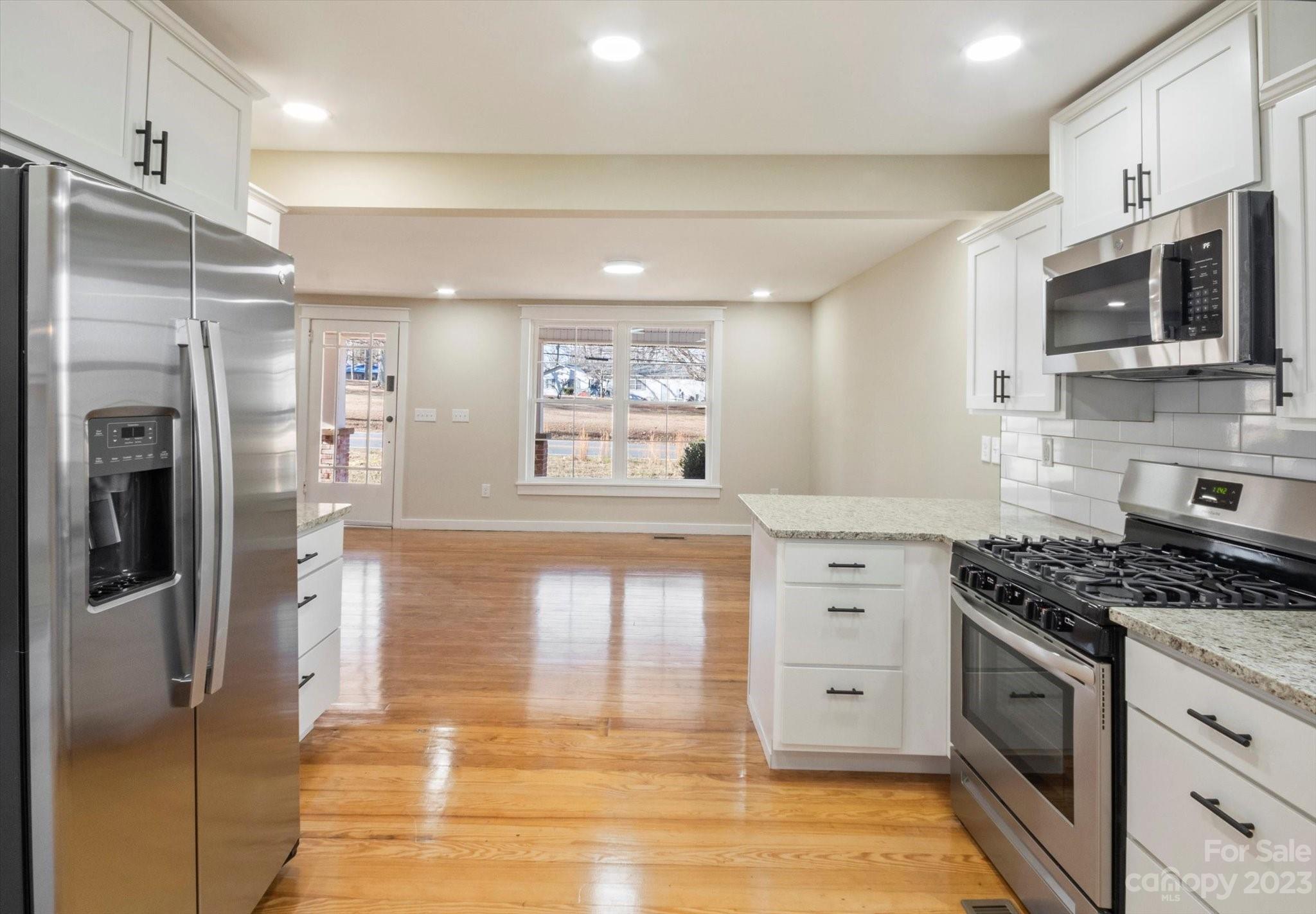 969 Peniel Road Columbus, NC 28722 - Photo 8 of 32 a kitchen with stainless steel appliances granite countertop a stove and a refrigerator