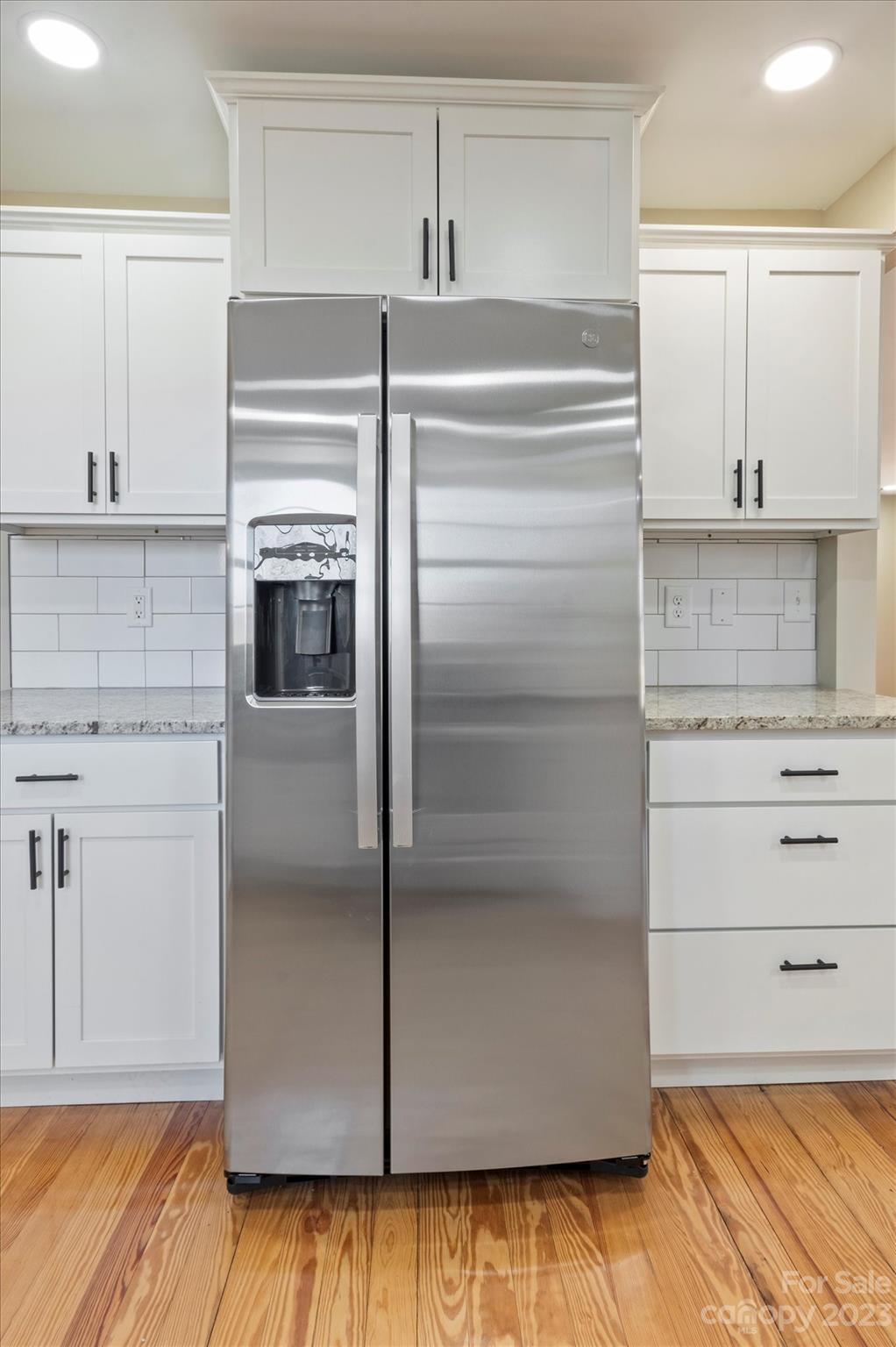 969 Peniel Road Columbus, NC 28722 - Photo 10 of 32 a kitchen with white cabinets and stainless steel appliances