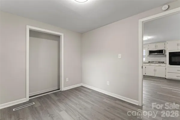 a view of a kitchen with a sink and a refrigerator