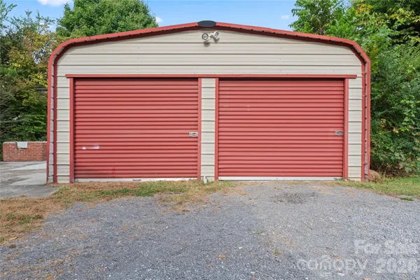 a view of a small house with a garage