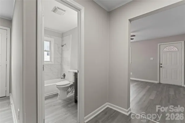 a bathroom with a granite countertop toilet and a sink