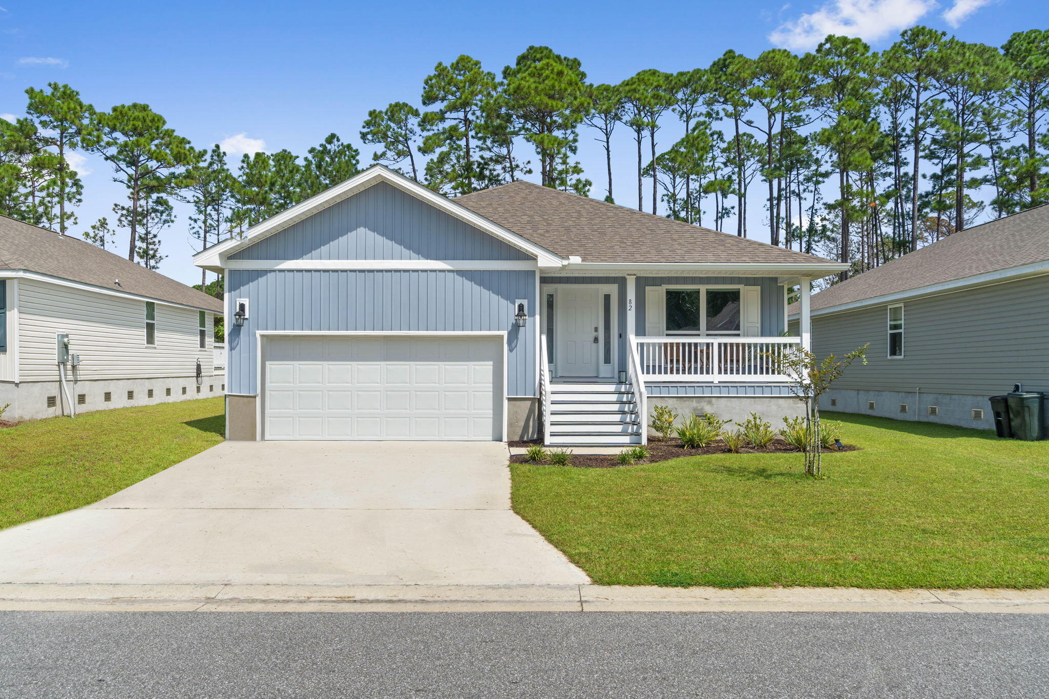 82 American Court Santa Rosa Beach, FL 32459 - Photo 1 of 47 a front view of a house with a yard and garage