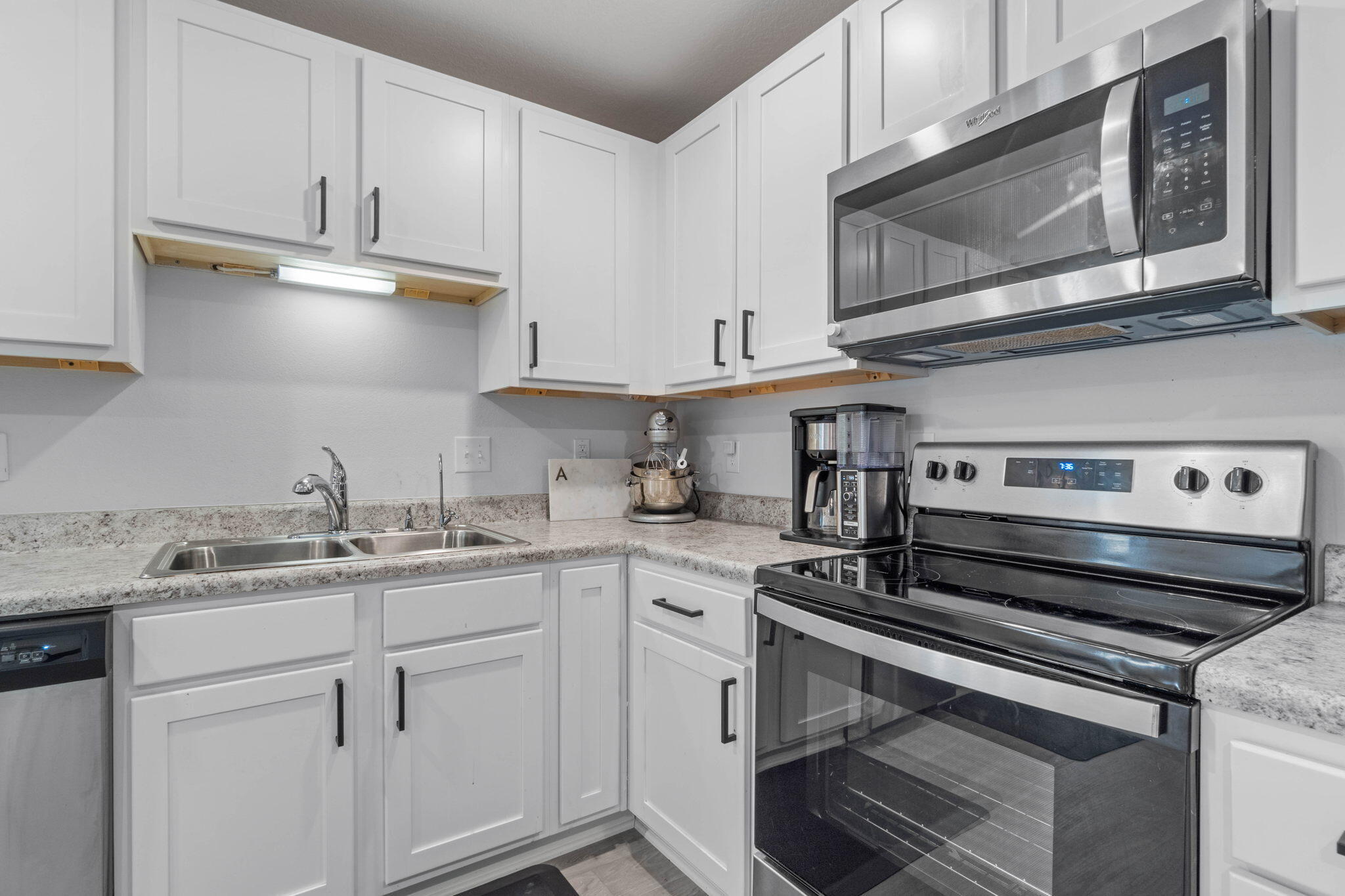 82 American Court Santa Rosa Beach, FL 32459 - Photo 14 of 47 a kitchen with stainless steel appliances granite countertop a sink a stove and cabinets