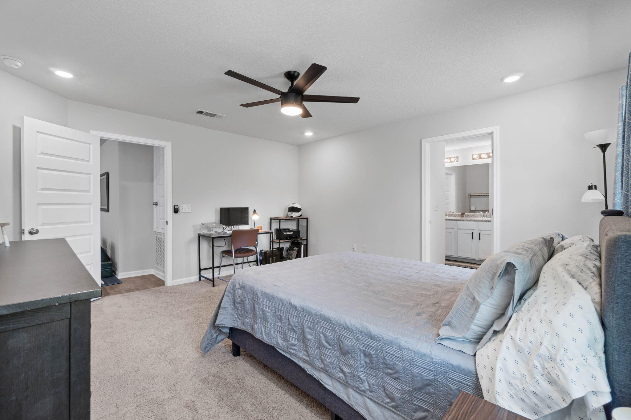 82 American Court Santa Rosa Beach, FL 32459 - Photo 23 of 47 a bedroom with a bed and a chandelier