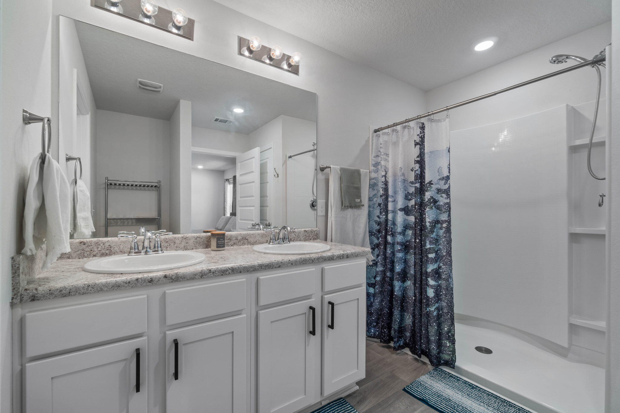 82 American Court Santa Rosa Beach, FL 32459 - Photo 24 of 47 a bathroom with a granite countertop sink a mirror a shower and a shower