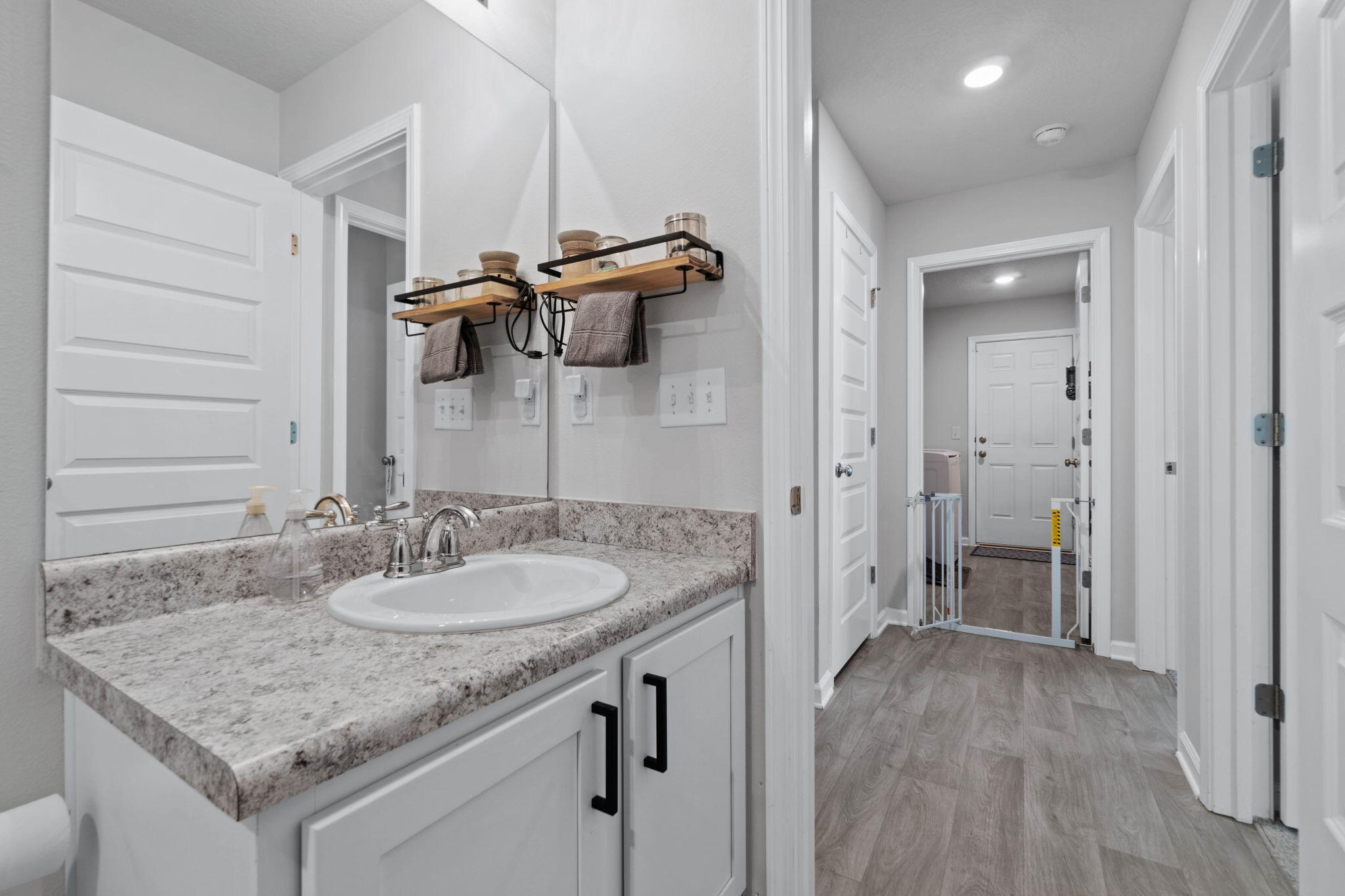 82 American Court Santa Rosa Beach, FL 32459 - Photo 31 of 47 a bathroom with a granite countertop sink a mirror and shower
