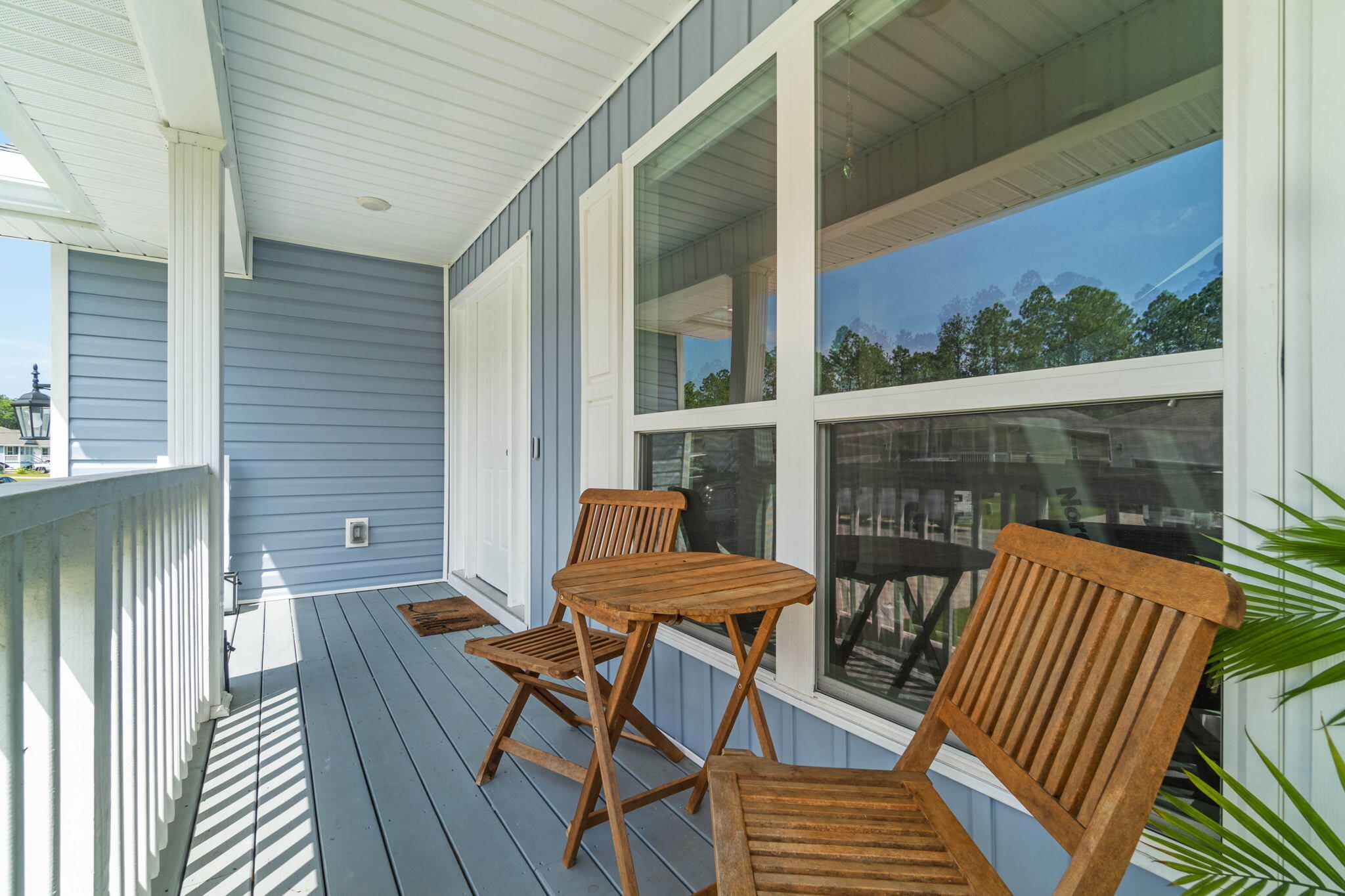 82 American Court Santa Rosa Beach, FL 32459 - Photo 6 of 47 an outdoor sitting area with furniture and wooden deck
