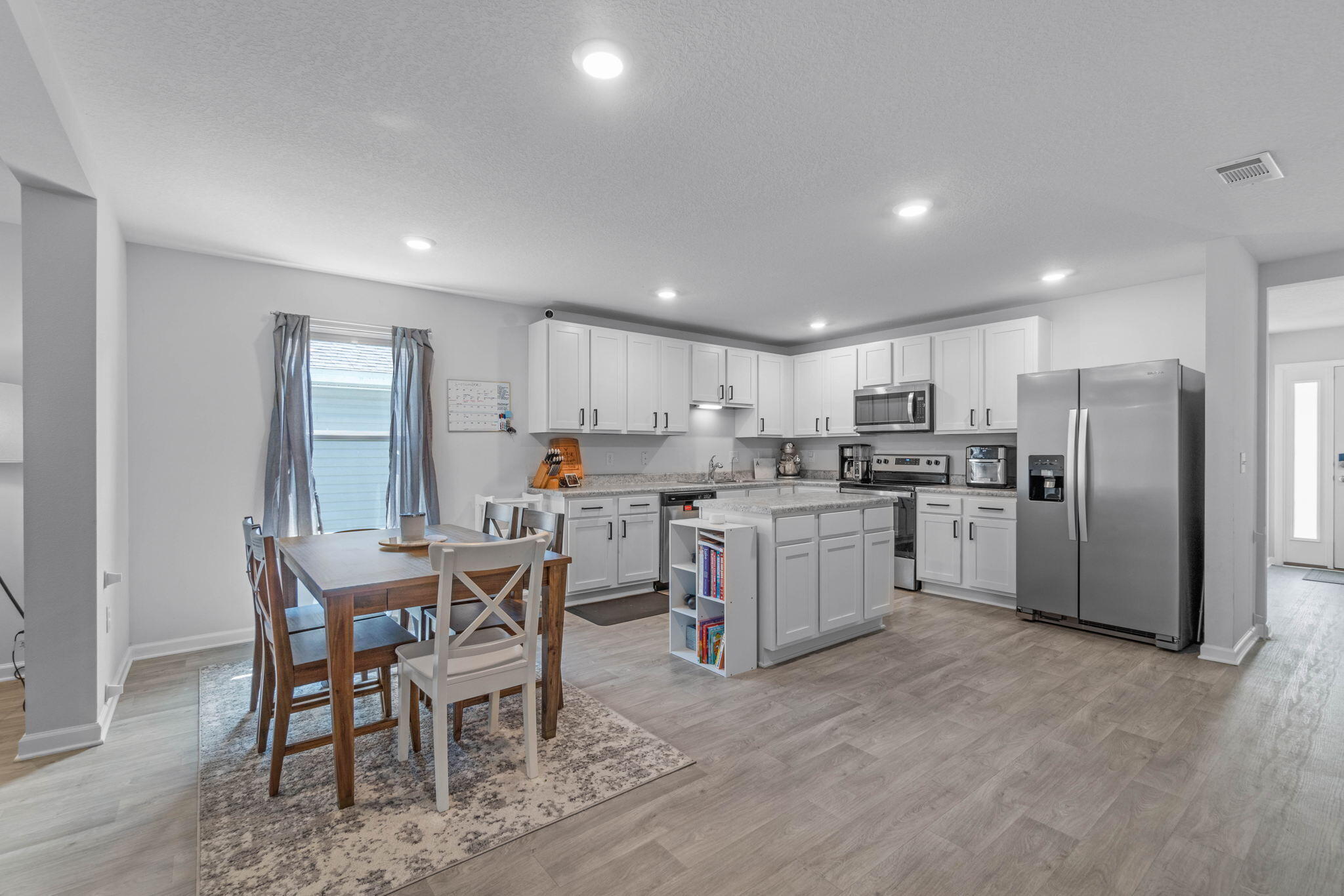 82 American Court Santa Rosa Beach, FL 32459 - Photo 10 of 47 a kitchen with white cabinets and stainless steel appliances