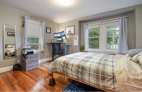 26-28 Normandy Road Auburndale, MA 02466 - Photo 15 of 31 a bedroom with a bed and wooden floor
