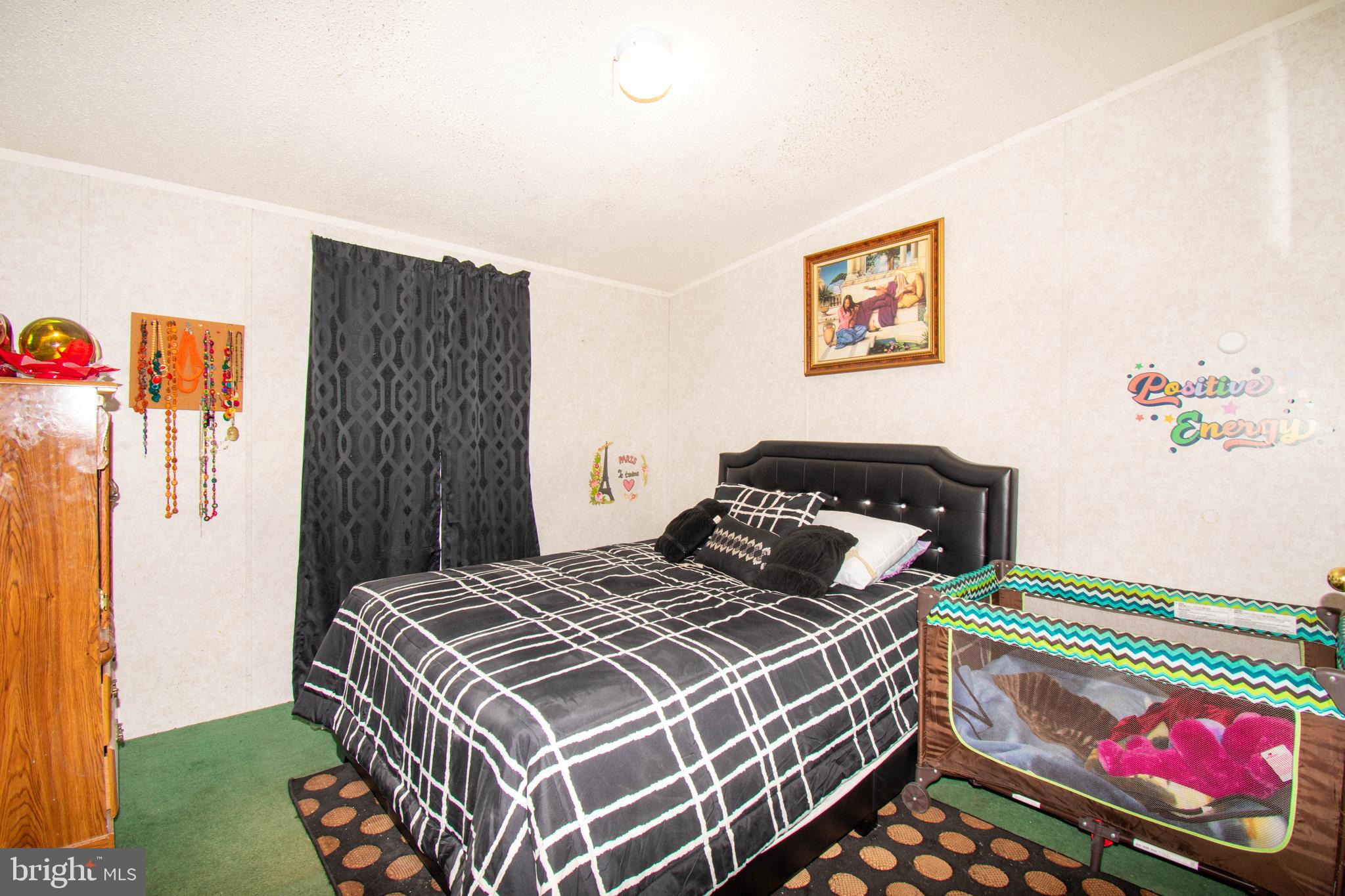 8791 Menokin Road Montross, VA 22520 - Photo 28 of 37 a bedroom with a bed and a dresser with wooden floor