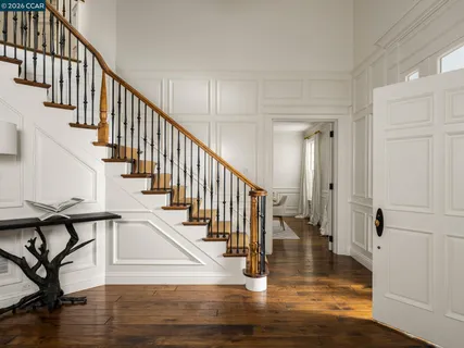 a dining room with furniture a rug and wooden floor