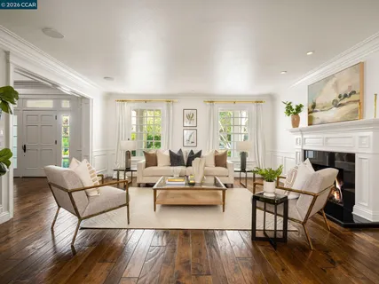 a view of a dining room with furniture a chandelier and wooden floor