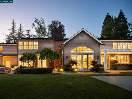 a view of a house with pool and chairs