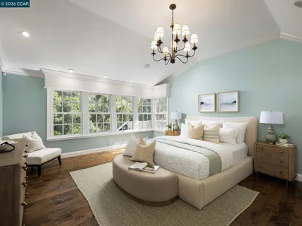 a dining room with furniture a rug and wooden floor