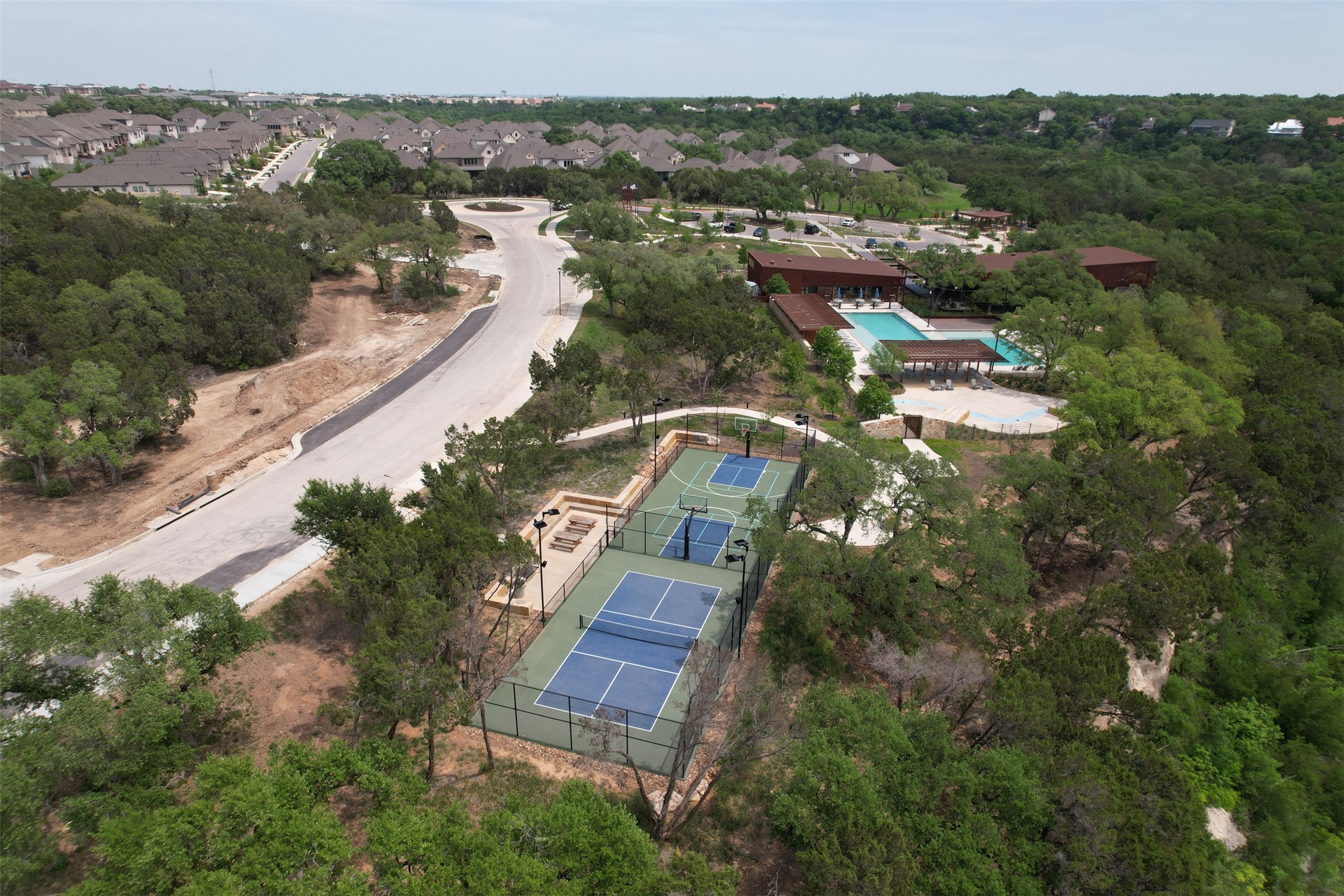 124 Cherry Ridge Road Georgetown, TX 78628 - Photo 22 of 23 Aerial view highlighting multiple sports courts, a swimming pool, and a community building