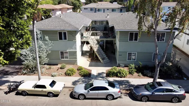 a car parked in front of a white house