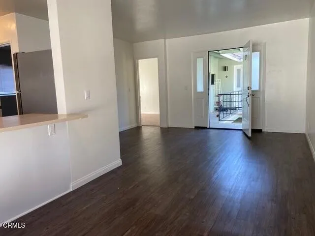 wooden floor in an empty room with a mirror
