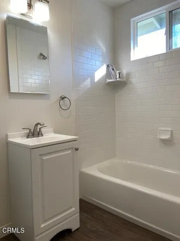a white bath tub sitting next to a white sink