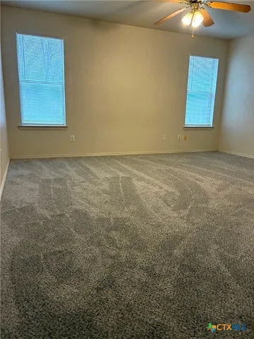 a bathroom with a granite countertop sink a toilet and shower