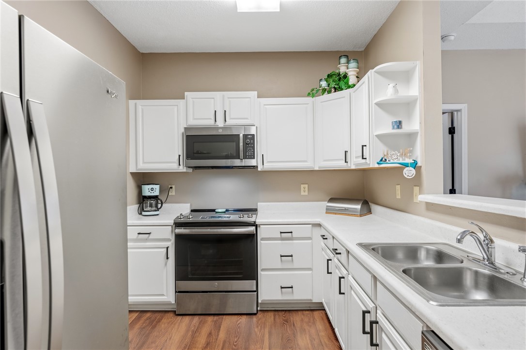 160 Wexford Drive, Unit 206 Anderson, SC 29621 - Photo 4 of 31 Kitchen features ample cabinetry, a double sink, and sleek stainless steel appliances.