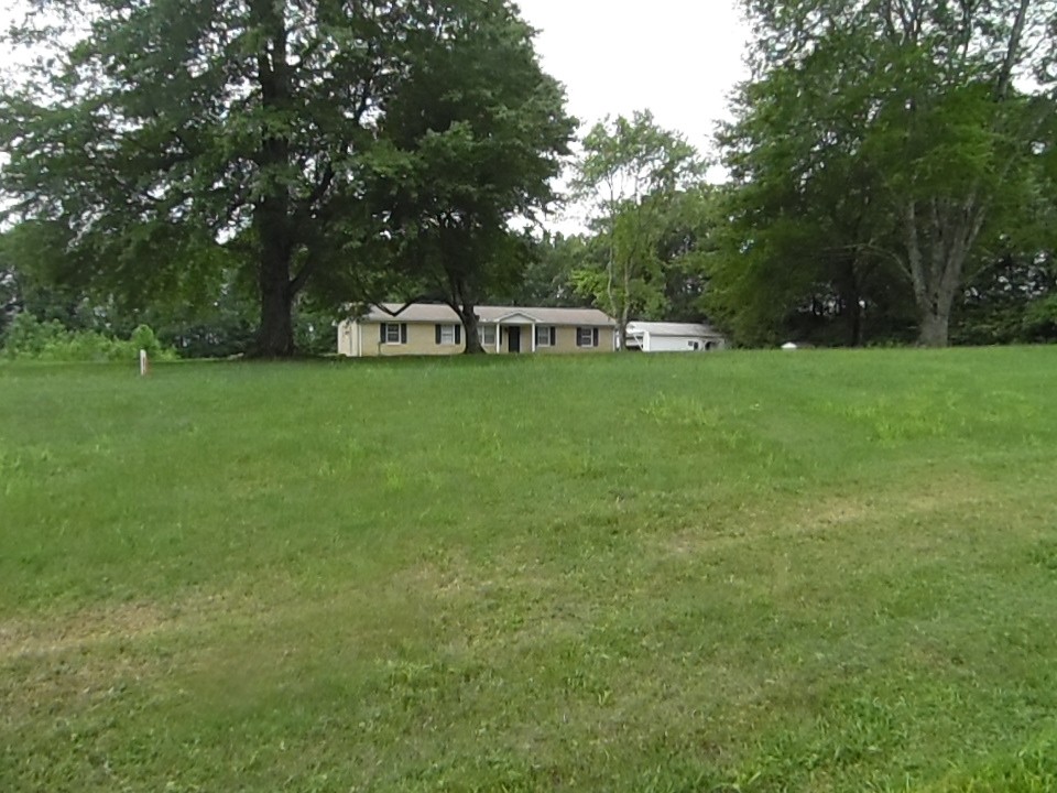 77 Old Quick Road Fayetteville, TN 37334 - Photo 3 of 23 a front view of a house with a garden