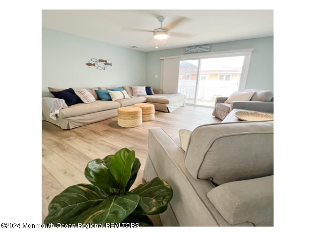 308 Harding Avenue, Unit WKLY SUMMER RENTAL Seaside Heights, NJ 08751 - Photo 12 of 25 a living room with furniture and a large window